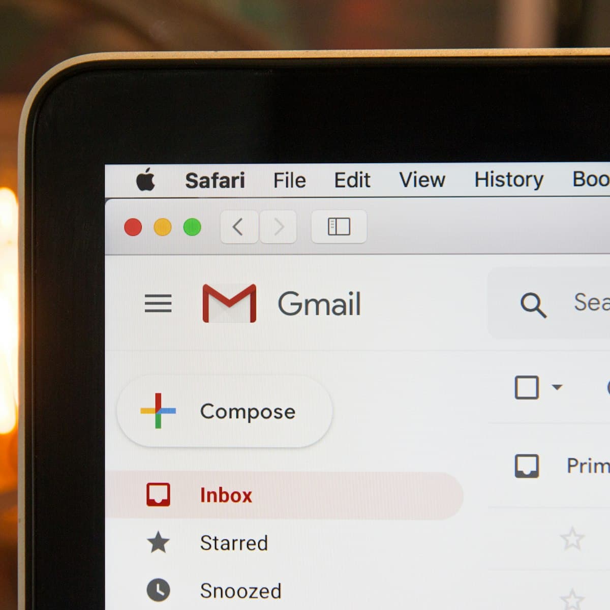 Email inbox open on a laptop beside a phone